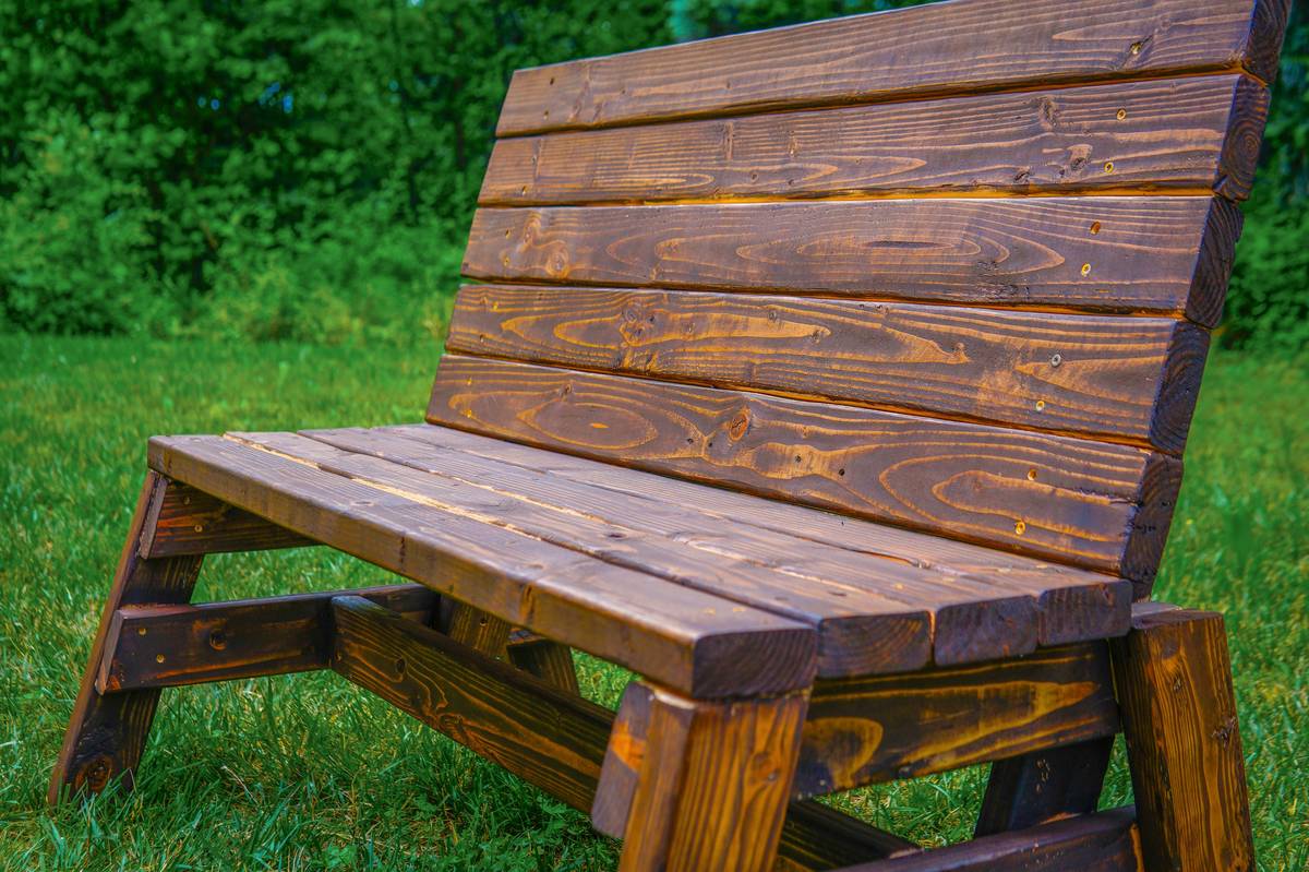 b and q benches outdoor installed on a paved patio beside matching dining chairs and potted lavender